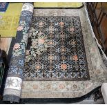 A large Chinese silk rug, blue ground, stylised floral decoration.