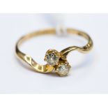 A diamond two stone 18ct gold ring, two round old brilliant cut diamonds, total approx 0.