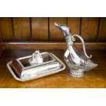 A silver plated claret jug in the form of a duck,