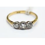 A diamond ring, graduated three stone and 18 ct gold ring,