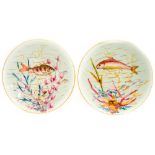 A pair of late 19th Century Crown Derby cabinet plates printed and tinted with fish,