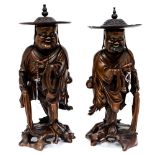 A pair of Chinese hardwood figures, holding beads and lash,