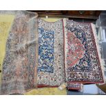 Red ground Persian carpet, stylised floral decoration, blue border, together with two other rugs,