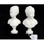After Jean Antoine Houdon, two wax busts of a boy and girl, each signed, on black marble bases,