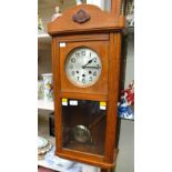 An oak cased wall clock