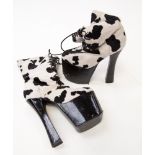 A pair of late 1970s/80s platform boots, synthetic black and white cow skin design,