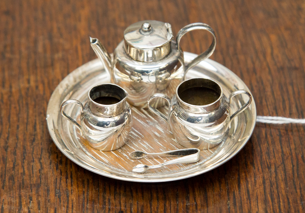 A miniature four piece Chester 1905 silver tea service with miniature tongs (5) 0.915 ozt/ 28.