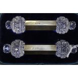 An Edwardian cased pair of silver and clear cut glass knife rests, maker Hassler Brothers,