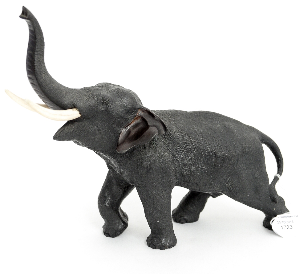 A Japanese Meiji bronze model of an elephant with raised trunk, signed Mitsumoto, circa 1868-1912,