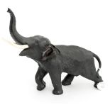 A Japanese Meiji bronze model of an elephant with raised trunk, signed Mitsumoto, circa 1868-1912,