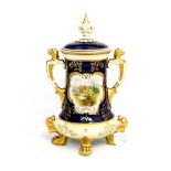 A Coalport twin handled vase and cover on four lion paw feet,