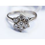 A diamond flower head cluster 18ct white gold ring,