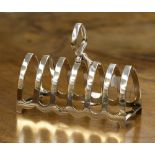 A silver seven bar toast rack, hallmark Birmingham 1931, maker W.J.