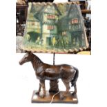 A table lamp with plaster base moulded as a horse with shade.