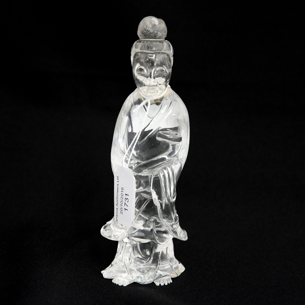 A Chinese carved rock crystal figure of a deity holding a ruyi, 17.