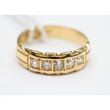 An five stone diamond and 18ct yellow gold ring, approx 5 mm width, ring size L,