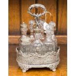 An early Victorian silver plated cruet set, the central section with a cast handle,