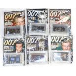 Five boxes of assorted James Bond collectables, comprising 007 model cars and magazines,