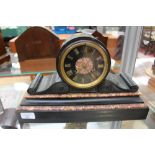 A Victorian black slate and red marble mantle clock, having an eight day movement,