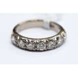 An 18ct white gold seven stone diamond ring, approx 1 carat spread, ring size O,