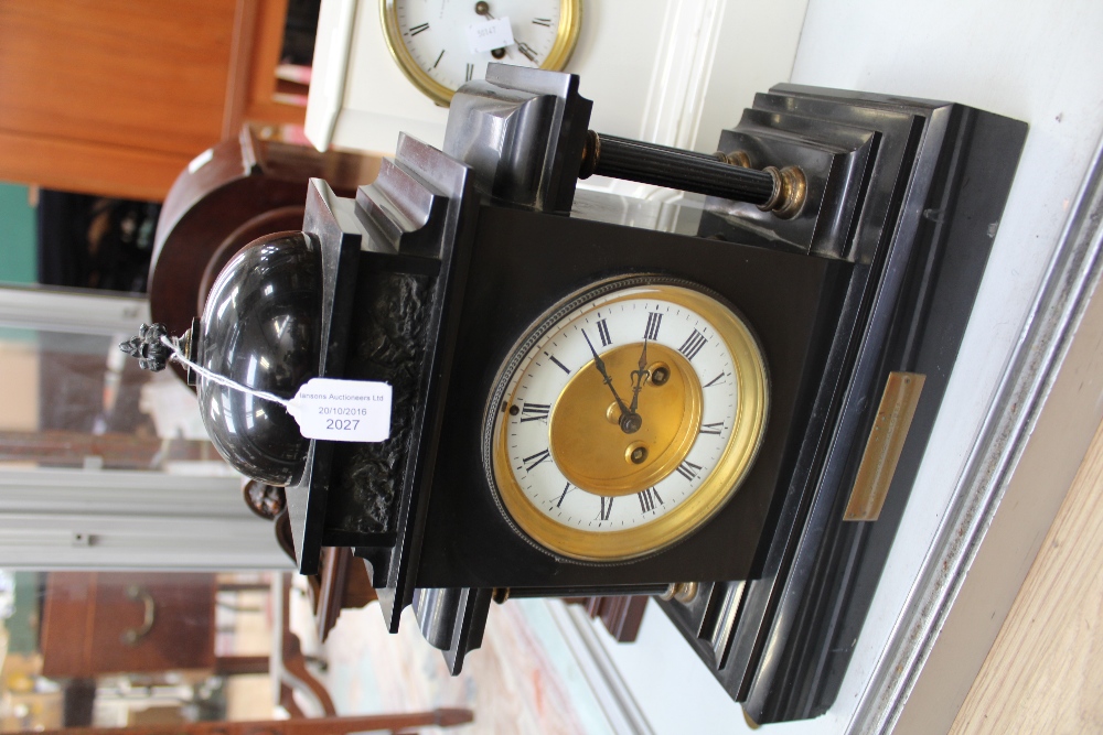 A black granite mantle clock, with four columns, having enamelled dial,