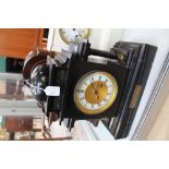 A black granite mantle clock, with four columns, having enamelled dial,