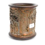 A Chinese carved bamboo brush pot, supported on three stump feet,