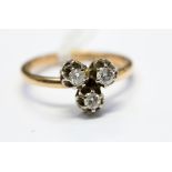 A diamond three stone 18ct gold ring, size 'N', 2.