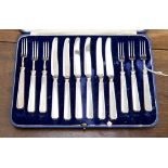 A cased Mappin and Webb dessert knife and fork set, with silver handles,