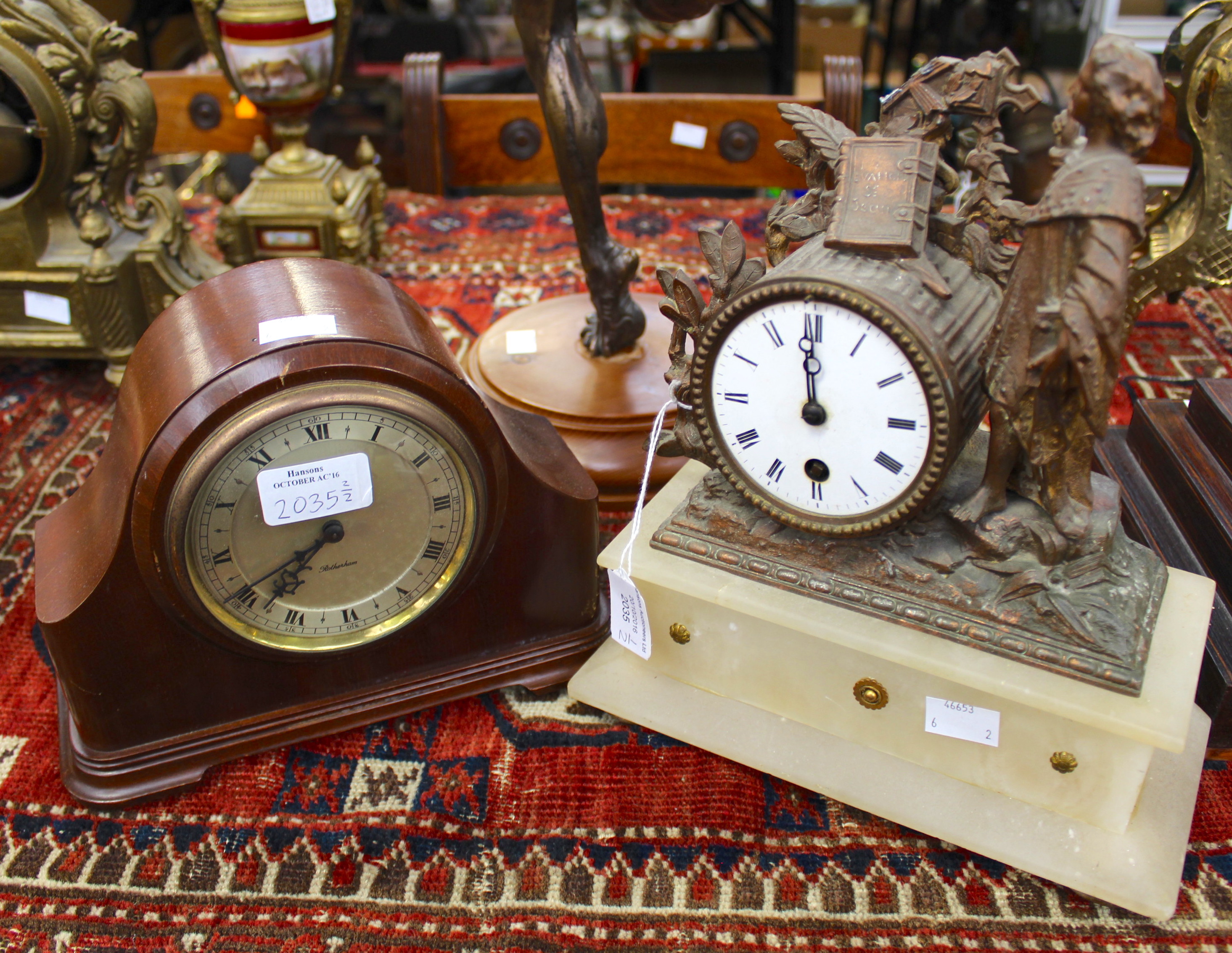 A spelter figural mantel clock (af) and a contemporary clock (2)