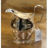 A helmet shaped silver cream jug, hallmark Sheffield 1904, maker Pearce and Sons,