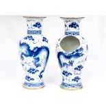 A pair of 20th Century blue and white vases in antique style with six character mark to the base