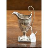 A George III silver helmet shaped cream jug on a square weighted base, hallmark London 1791,