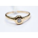 A diamond and 14ct gold solitaire, bezel set, modern round brilliant diamond, approx 0.