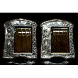 A pair of Arts and Crafts silver photograph frames,