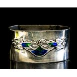 Archibald Knox for Liberty, a silver and enamelled napkin ring,