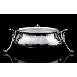 An Arts and Crafts planished silver bowl, ogee form, supported on three open tricorn feet,