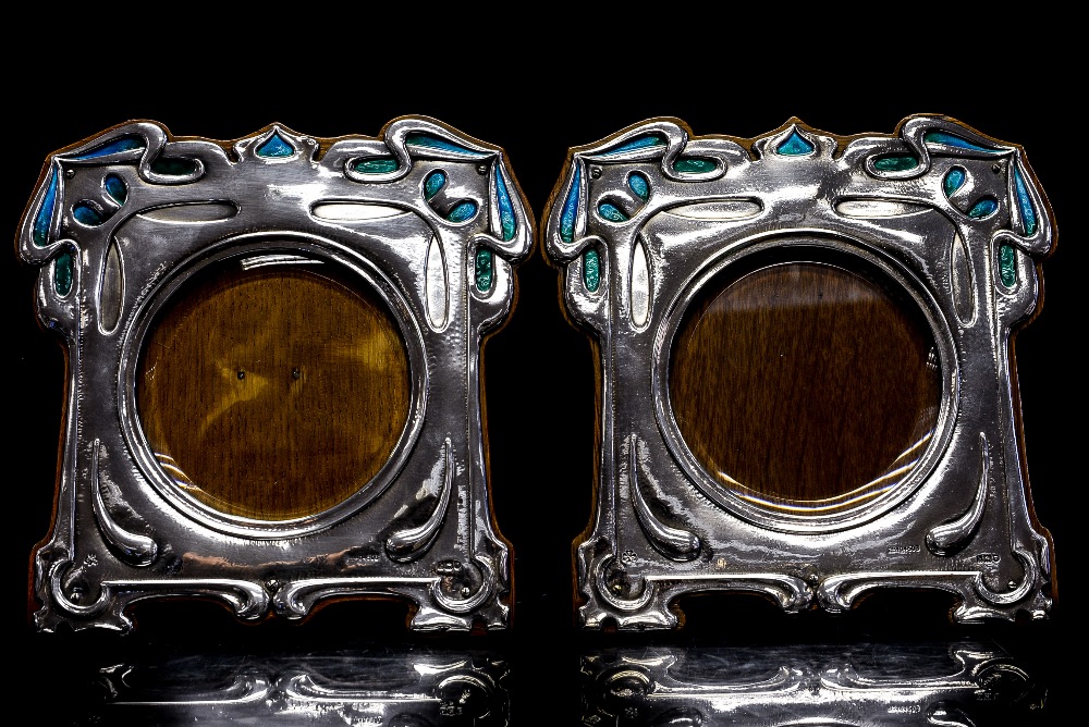 A pair of Art Nouveau silver and enamelled photograph frames, stylised foliate design,