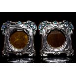 A pair of Art Nouveau silver and enamelled photograph frames, stylised foliate design,