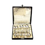 A cased set of twelve Danish silver coffee spoons, with open foliate terminals, 1951, marked,