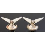 A pair of Edwardian silver and mother of pearl knife rests, the mother of pearl carved as wings,