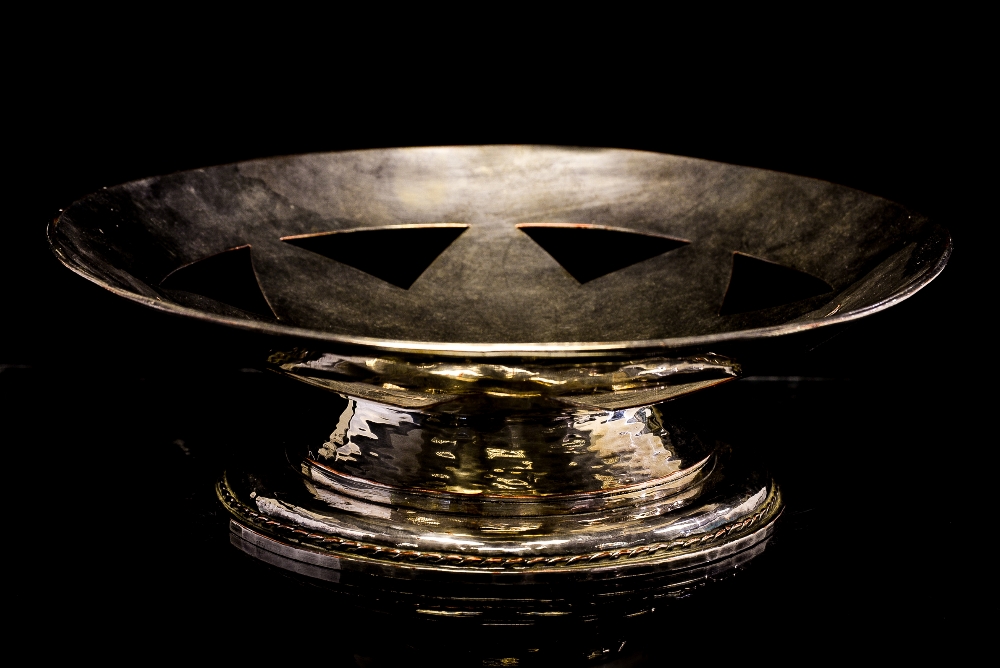 An Arts and Crafts silver plated pedestal bowl, hand hammered silver on copper,