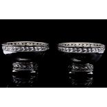 A pair of Arts and Crafts silver bowls, planished form with reticulated cast leaf rim and foot,