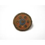 Roman Enamelled Disc Brooch A cast bronze disc brooch decorated with red and blue champleve enamel