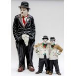 A large Charlie Chaplin figure together with Laurel & Hardy duo figure