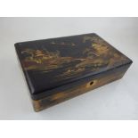 An early 20th century Chinese lacquered box, the hinged lid decorated with birds flying over a