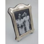 A white metal easel-back photograph frame, stamped 925.