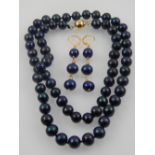 A South Sea black pearl necklace, 20 inches, having yellow metal ball clasp, together with a pair of