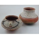 Two hand-made Peruvian clay pots, having painted geometric decoration.