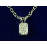 A white metal and emerald cut diamond pendant, the stone of approx. 0.60 carats, suspended on a